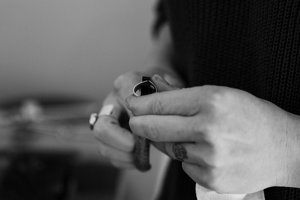 Using pliers to form the sterling silver ring band